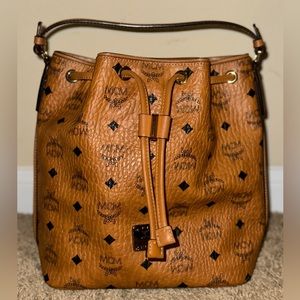 AUTHENTIC: MCM Essential Drawstring in Visetos Original Cognac Small